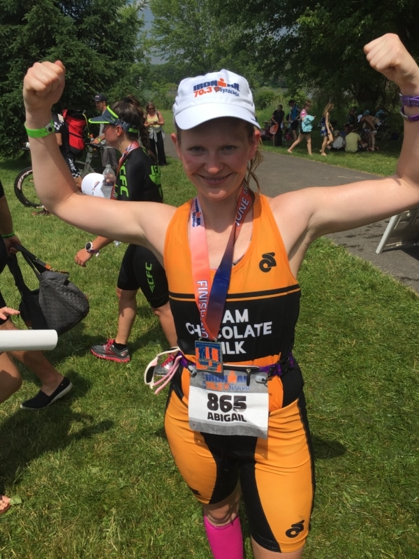 Woman flexing her muscles after completing a triathlon