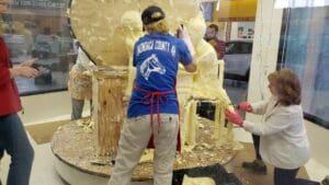 person sculpting the butter