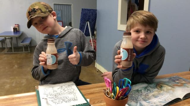 kids with chocolate milk bottles