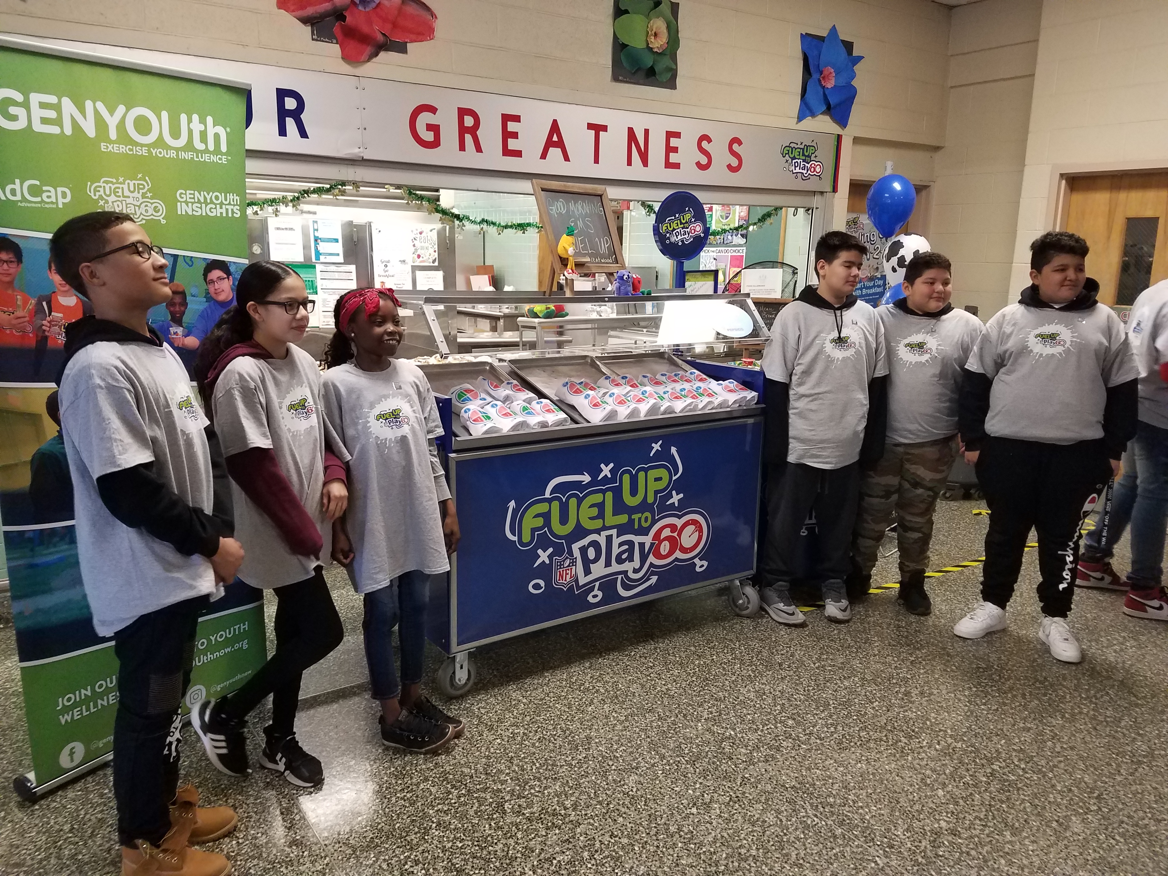 group of students with a grab and go station at school