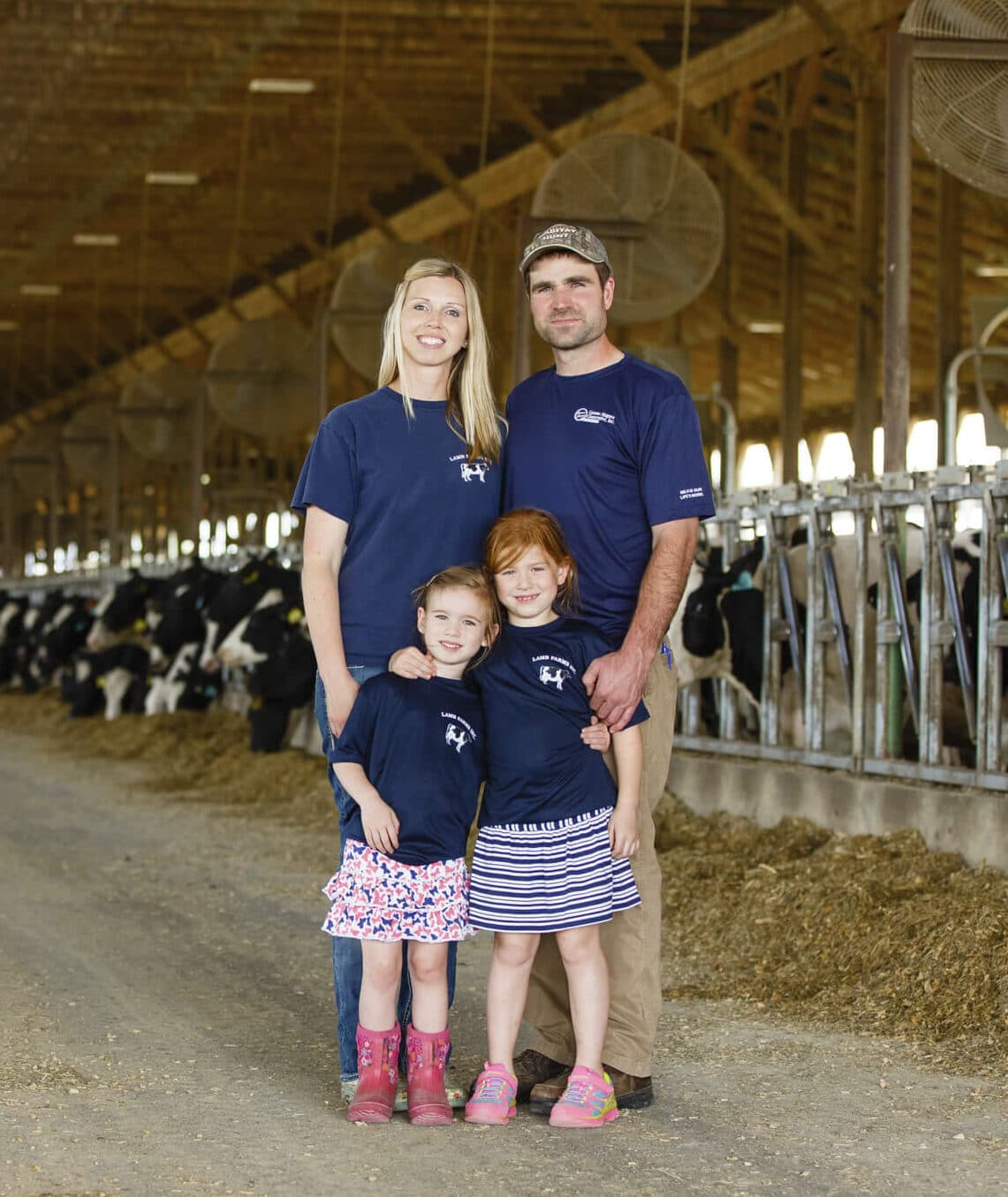 Family posing inside of a barn