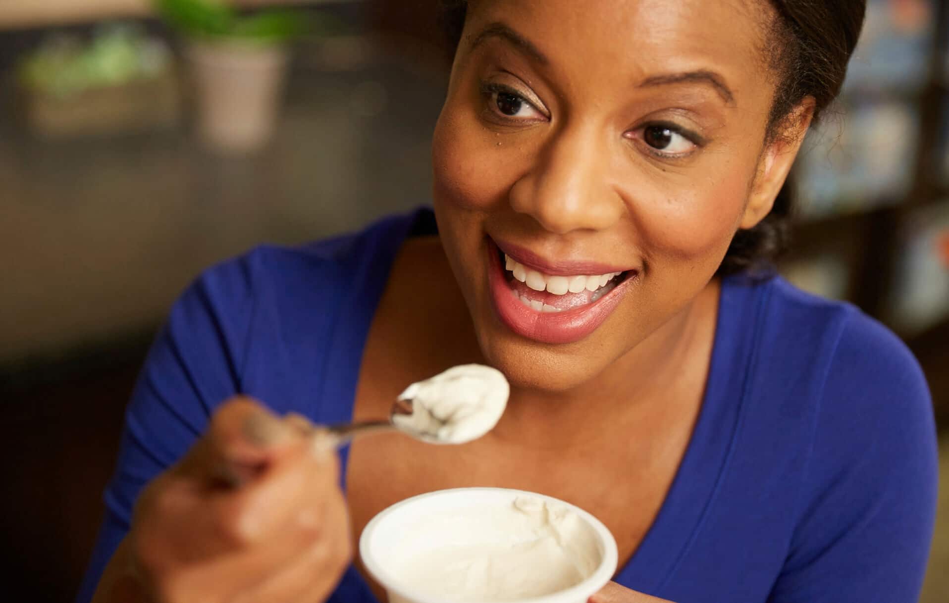 Woman eating a bowl of yogurt