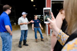 someone taking a photo of a farm tour on their phone