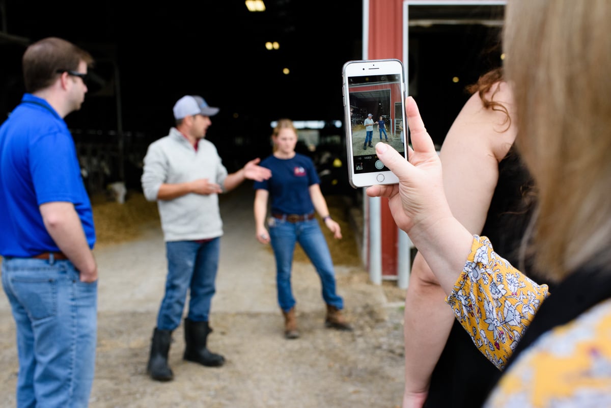 someone taking a photo of a farm tour on their phone