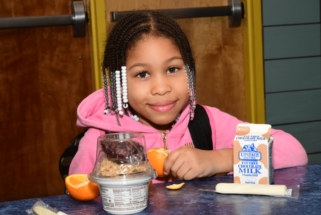 Girl smiling with a school lunch