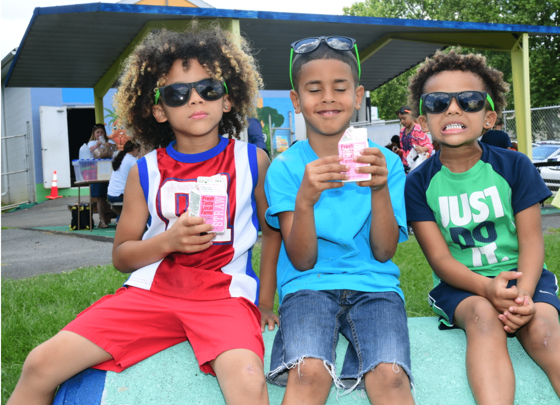 Kids enjoying strawberry milk outside