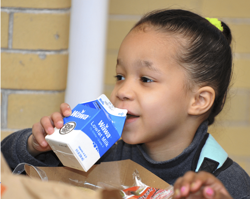Girl drinking a carton of milk